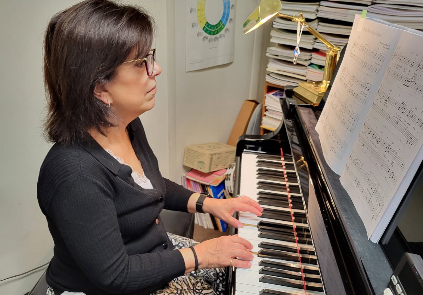 ENGLERT-ADULT FEMALE PLAYING PIANO