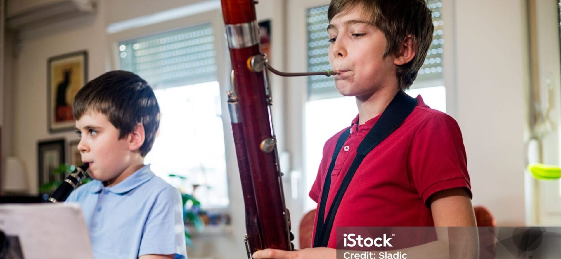 BOY PLAYING BASSOON AT MUSIC STUDIO-istockphoto-1300130139-2048x2048