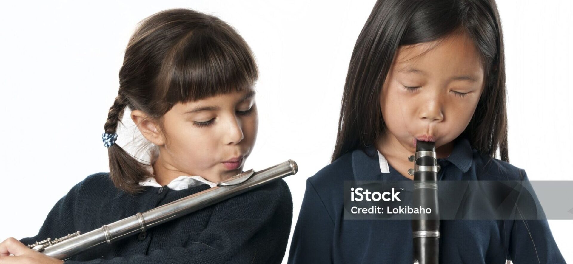 Two kindergarten students playing flute and clarinet